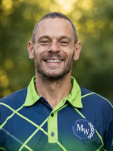 MetsonWorld Logistics driver in a branded blue and green shirt